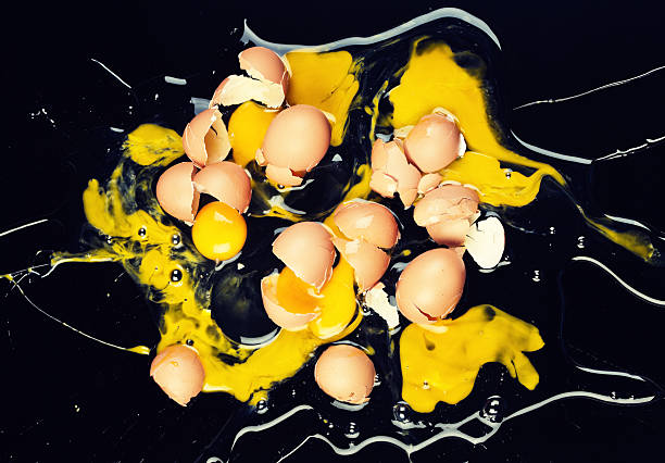 istock Domestic disaster! Dozen eggs dropped and smashed on black 523540377