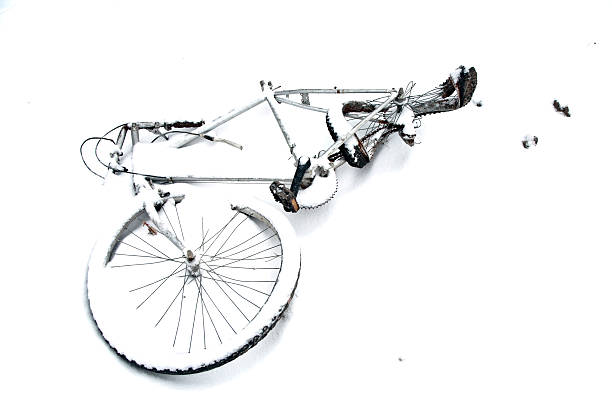 damaged old bicycle in wintertime covered by snow