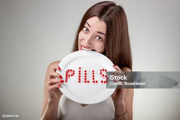 Young Woman Bites Plate With Pills Stock Photo - Download Image Now - Adult, Adults Only, Beauty