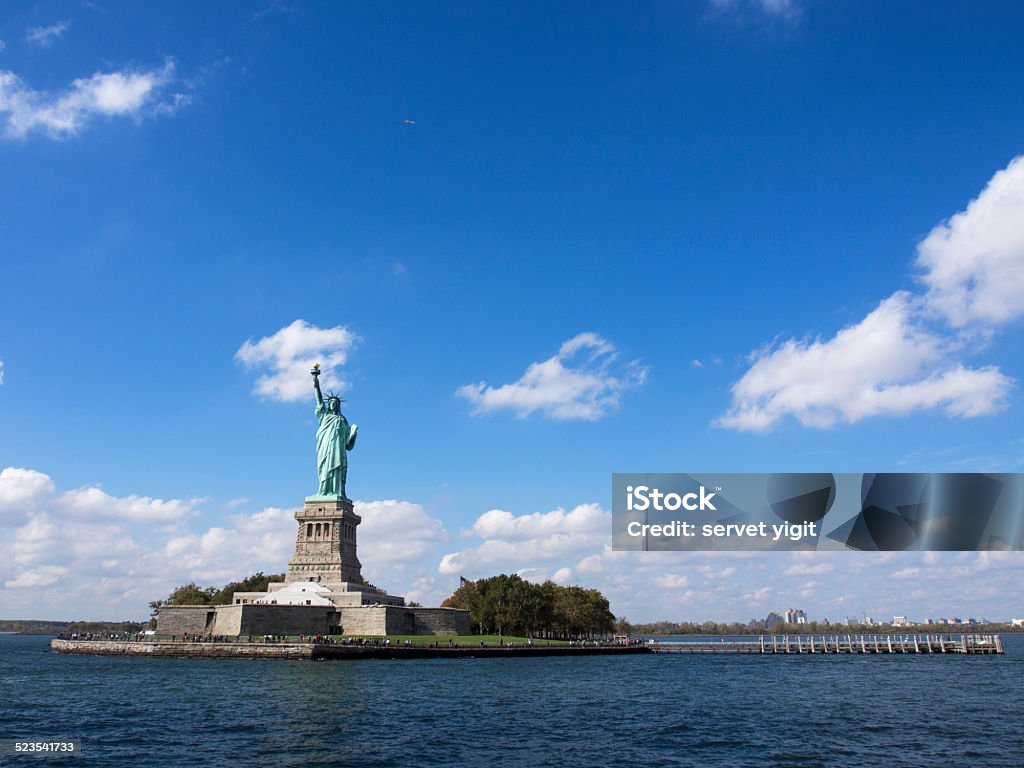 Statue Of Liberty With Skyline Blue Stock Photo