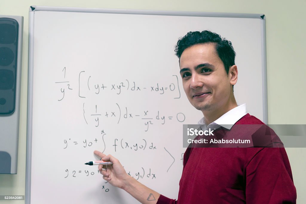 Student Explaining Math at Secondary School, University inIstanbul, Turkey Male student doing math at the whiteboard, Istanbul, Turkey. Nikon D800, full frame. Serious Stock Photo