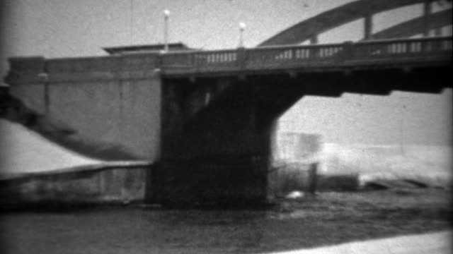 1936: New Deal area bridge construction completed across canal waterway.