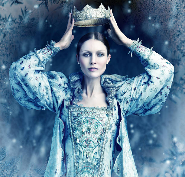 The ice queen cometh Shot of queen holding a crown over her head with snow falling around her coronation photos stock pictures, royalty-free photos & images