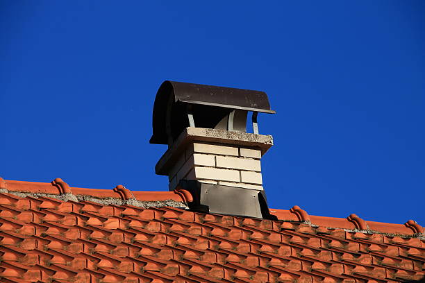istock Red tile roof whith chimney 523559791