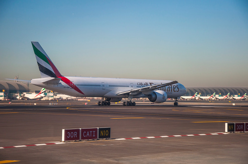 Dubai, United Arab Emirates - November 12, 2014: Emirates Boeing 777-200 take off at Dubai International Airport Terminal