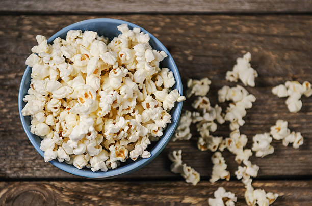 istock Popcorn in a bowl on wooden table 523563083