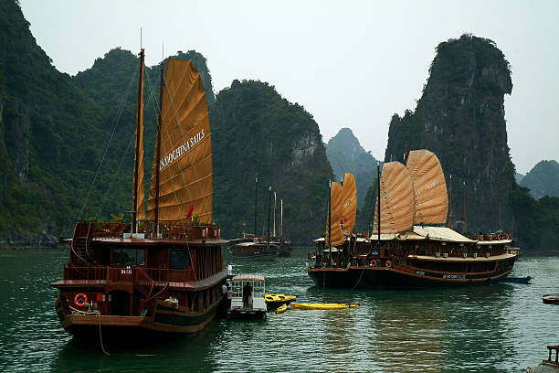 Quang Ninh,Vietnam-February 28,2014 : Large Junk ship overwhelmingly take tourist are typical in this region . More than 3,000 Islands are found in the area of Halong Bay in the Gulf of Tonkin on February 28,2014 in Halong Bay,Vietnam.