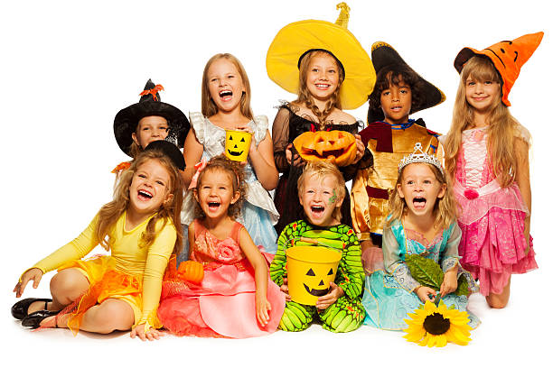 istock Many kids sit in group wearing Halloween costumes 523577261