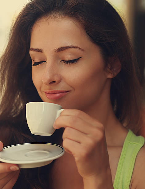 istock Beautiful happy woman drinking coffee with closed eye 523577759