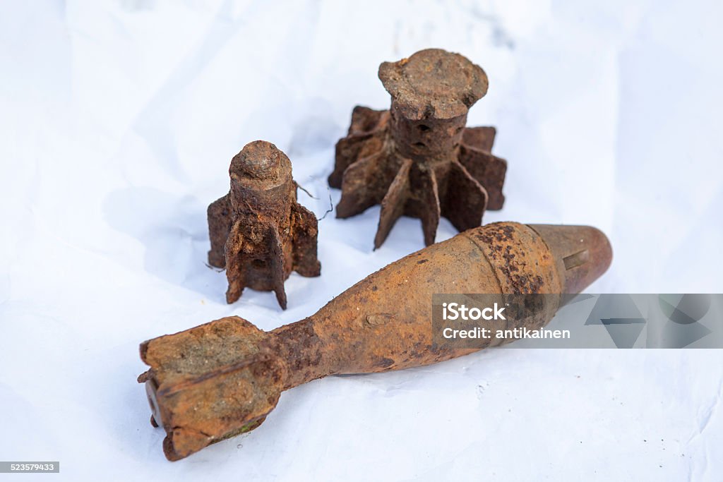 Old rusted fougasse and it parts on white sheet paper Old rusted Soviet fougasse and it parts on white sheet of papers Weapon Stock Photo