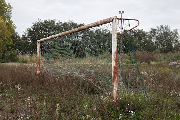 Abandoned rusty soccer goal stock photo