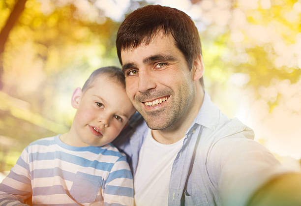 istock Father and son taking selfie in nature 523582507