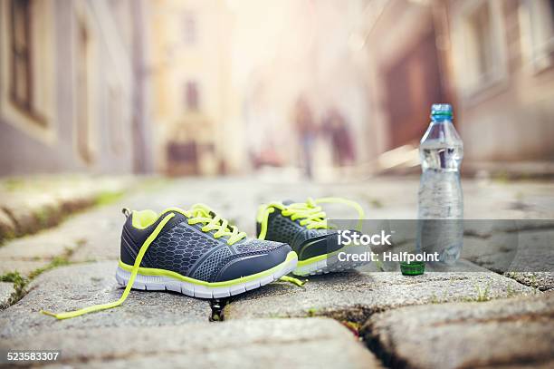 Running Shoes And Bottle Of Water Stock Photo - Download Image Now - Blue, Bottle, City