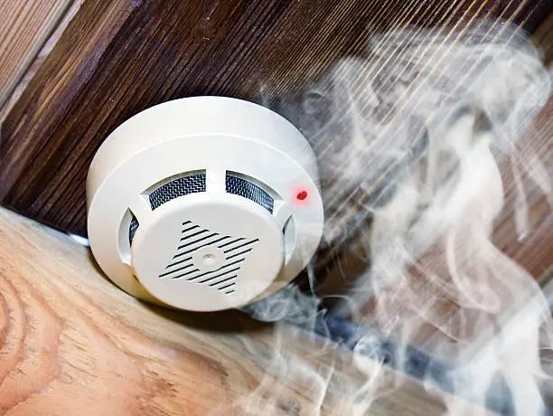 White smoke detector in wooden room