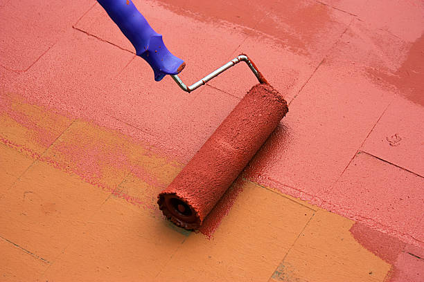 istock Contract painter painting a floor with a paint roller 523596433