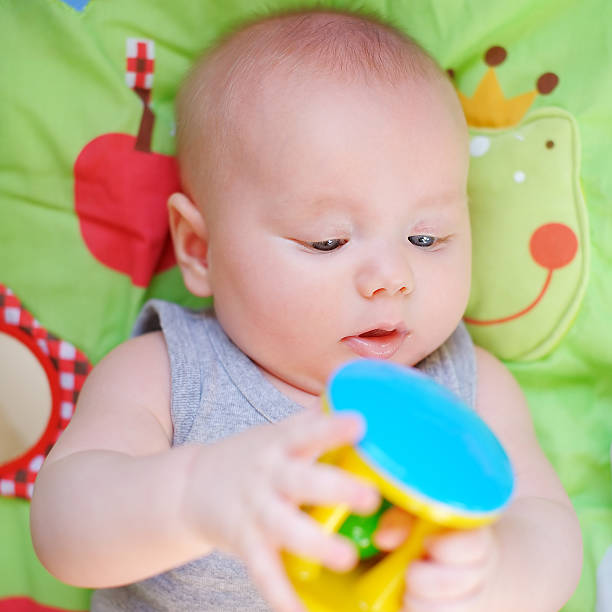 istock Baby play with bright toy 523597349