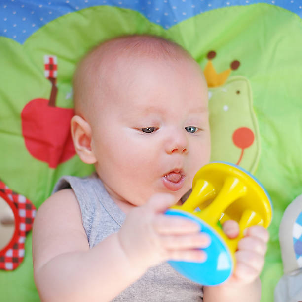 istock Little baby play with bright toy 523597361