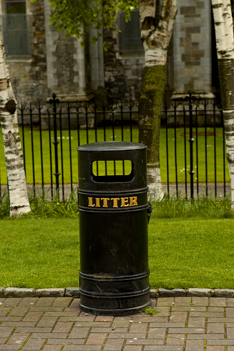 cast iron container, in the city of Dublin for litter, with nature background