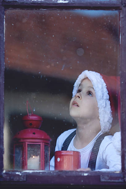 istock Adorable boy, looking through window, waiting for Santa 523601917