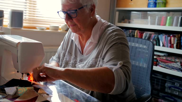 Happy Senior Woman Doing a Hobby Sewing A Quilt