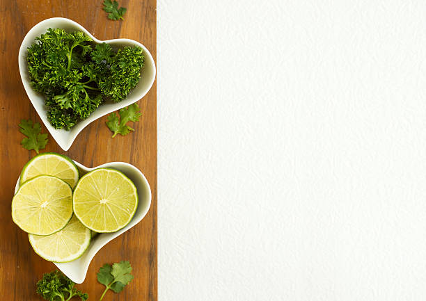 istock Freshly cut lime and greenery in two heart shaped plates 523614366