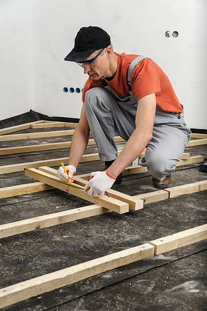 istock Worker measures off a wooden beam. 523614824