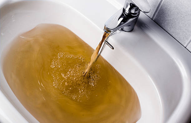 istock Dirty brown water running into a sink 523615024