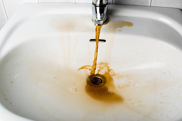 istock Dirty brown water running into a sink 523615158