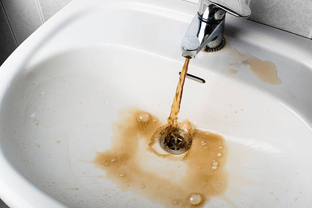 Dirty brown water running into a sink Dirty brown water running into a white sink. Looks very unhealthy, dirty stock pictures, royalty-free photos & images