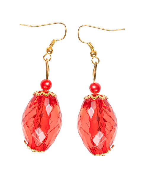Earrings in red glass with gold elements. white background