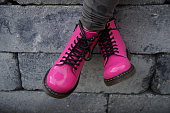 istock Pink punk alternative girl or woman shoes - cross legged 523615915