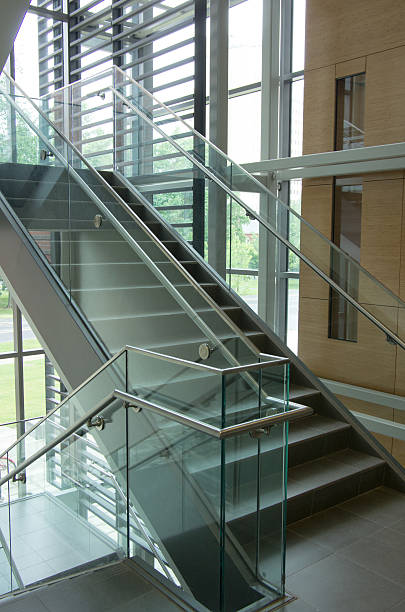 Glass and granite staircase with stainless steel handrails. A glass and granite staircase with stainless steel handrails. university of massachusetts amherst stock pictures, royalty-free photos & images