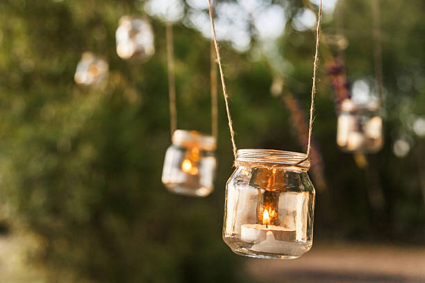 mason jar candle hanging on tree for wedding decor mason jar candle hanging on tree for wedding decor sand river stock pictures, royalty-free photos & images