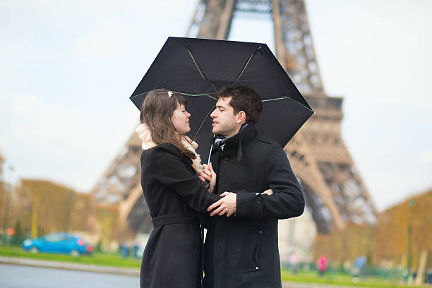 istock Couple with umbrella near the Eiffel tower 523617367