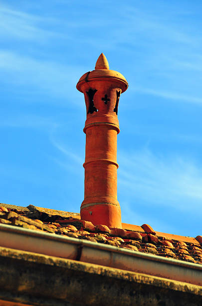clay chimney and sky Béjaïa, Kabylia, Algeria: ceramic chimney on a tiled roof and sky - upper kasbah  kabylie stock pictures, royalty-free photos & images