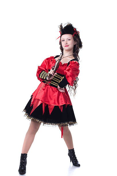 istock Bold young girl posing in pirate costume with gun 523619061