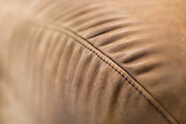 istock Sofa Edge Detail Texture of Brown Leather with Stitching 523619262