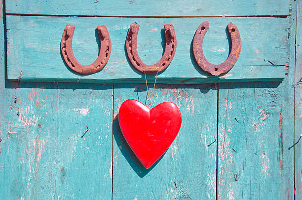 istock three rusty horseshoe luck symbol and red heart on door 523619827