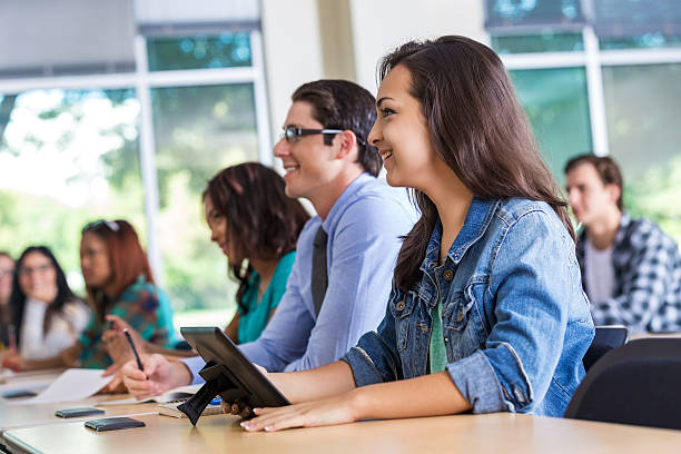 istock Diverse group of students listening to speaker in college classroom 523620383