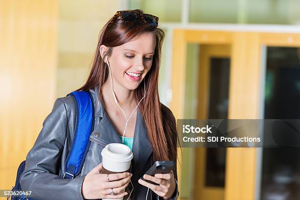 Pretty Young College Woman Using Smart Phone After Class Stock Photo - Download Image Now