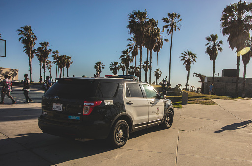Los Angeles, USA - April 17, 2016: An editorial stock photo of the Venice beach boardwalk in Los Angeles. The photo shows an LAPD police car patrolling the area. Venice is a residential, commercial and recreational beachfront neighborhood on the Westside of the city of Los Angeles.