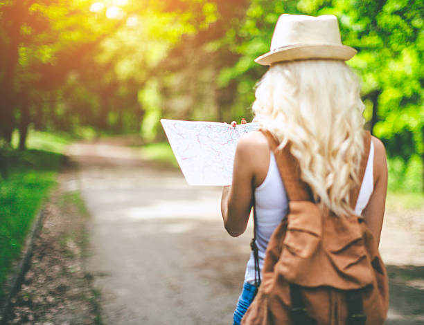 istock back view of young woman with backpack 523623760