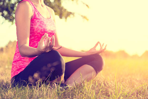 istock Young athletic woman practicing yoga on a meadow at sunset 523625828