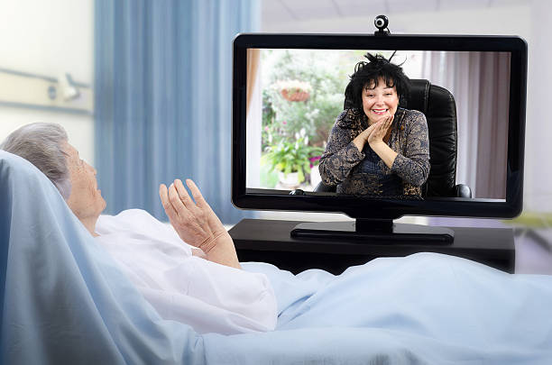 istock Senior woman on hospital bed has video chat 523626648