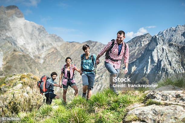 Group Of People Hiking The Mountain Togetherness Stock Photo - Download Image Now - Hiking, Mountain, Group Of People