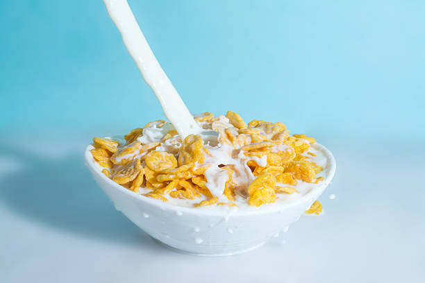 istock splash milk in bowl with yellow cornflakes 523628628
