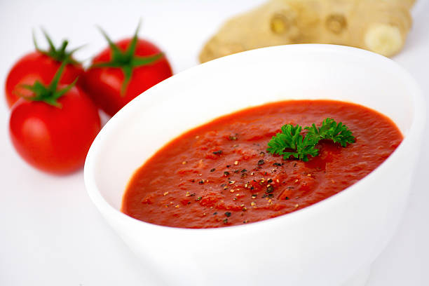 istock Tomato soup with ginger and parsley in white bowl 523631411