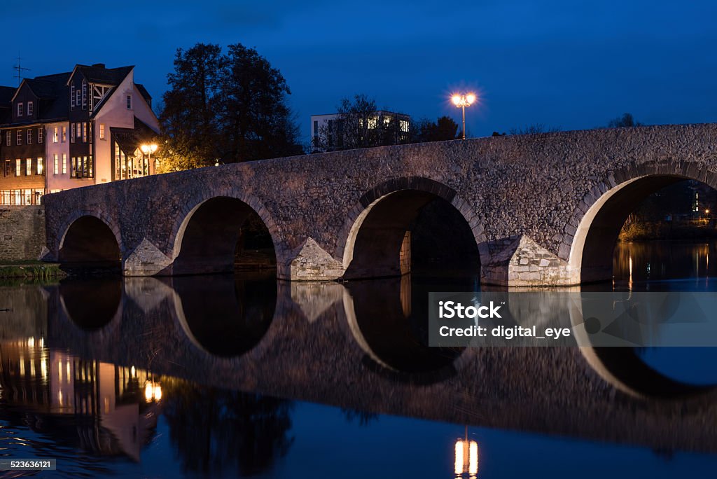 Wetzlar and its old bridge over the river Lahn Old medieval bridge over the river Lahn in Wetzlar, Germany. Taken in november 2014 at dusk. Stone Material Stock Photo