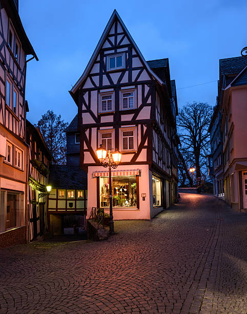 Wetzlar / Germany - november 15, 2014: Old half-timbered houses and streets in the old parts of the town of Wetzlar. A small store in one of the houses. Street lanterns.