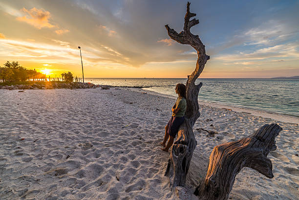 istock Woman on the beach at sunset 523647245